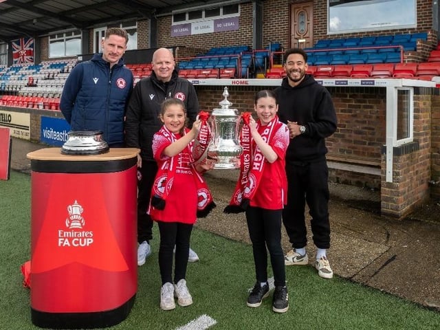 Sophia Paviour, aged 10 (front left) and Amelie Paviour, aged 12 (front right) with Eastbourne Borough's goalkeeper Lee Worgan, manager Danny Bloor and presenter Josh Denzel. Picture from Emirates