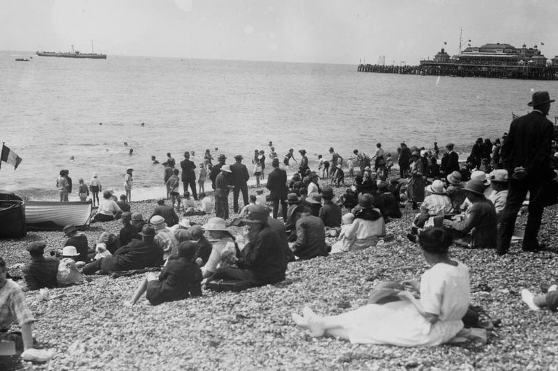 A few people venture into the sea, but most stay safely on the beach at Brighton. The picture was taken in 1915 as WW1 rages not so far away across the sea.