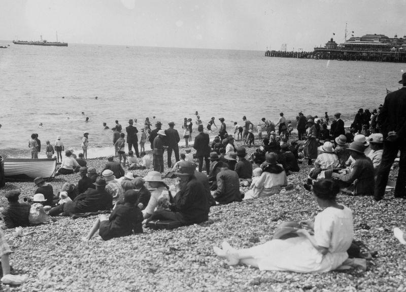 A few people venture into the sea, but most stay safely on the beach at Brighton. The picture was taken in 1915 as WW1 rages not so far away across the sea.