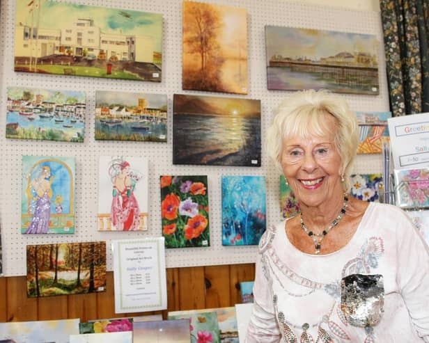 Sally Cooper at the festival in 2019 with her striking paintings and cards that have been part of it since the start, more than 50 years ago. Picture: Derek Martin DM1980078a