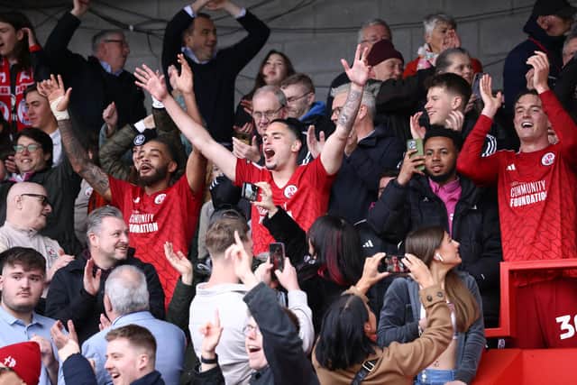 Crawley Town's Jay Williams, Klaidi Lolos and Will Wright celebrate with fans | James Boardman / Stephen Lawrence / Telephoto Images