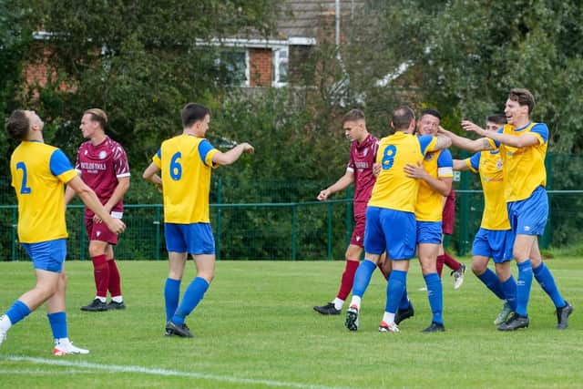 Frankie Chappell celebrates with teammates after opening the scoring for Eastbourne Town | Picture: Josh Claxton