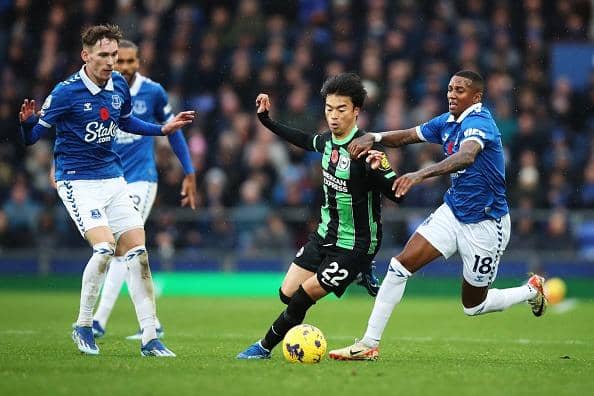 Kaoru Mitoma of Brighton & Hove Albion is challenged by Ashley Young of Everton during the Premier League match