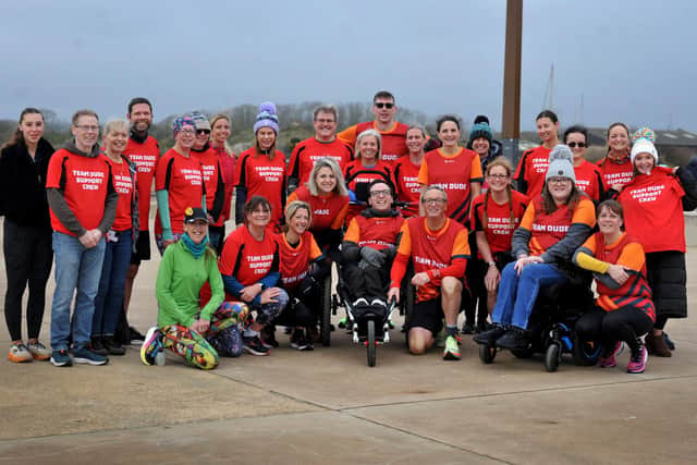 Team Dude assisted wheelchair team, Stephen Merridue and his dad David, with Littlehampton Prom parkrunners, celebrating winning a place in the 2024 London Marathon. Picture: SR24020301 SR Staff / Sussex World