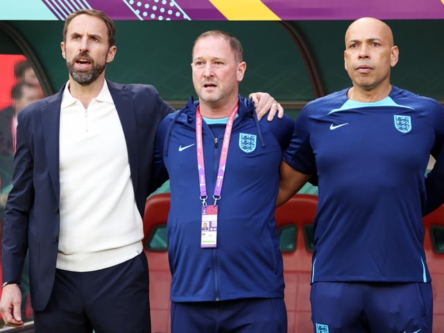 DOHA, QATAR - NOVEMBER 21: Gareth Southgate, Head Coach of England, stands for the national anthem with their team during the FIFA World Cup Qatar 2022 Group B match between England and IR Iran at Khalifa International Stadium on November 21, 2022 in Doha, Qatar. (Photo by Clive Brunskill/Getty Images)