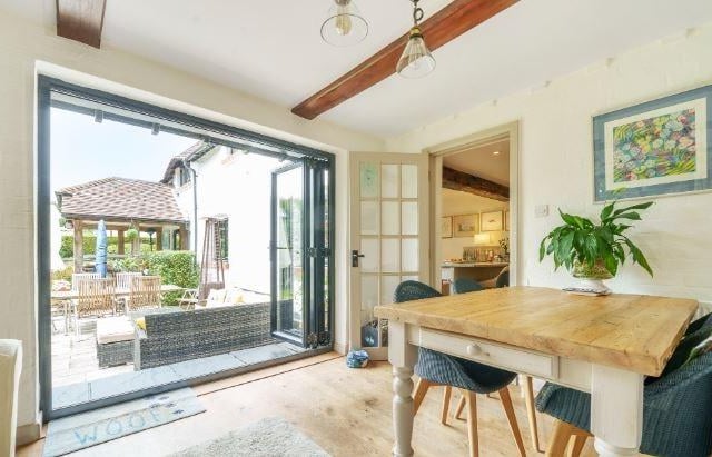A door from the kitchen leads into a separate double aspect morning room, which features bi-fold doors giving access to the rear garden