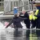 Still from footage depicts James Corden falling into water whilst filming in Eastbourne's Sovereign Harbour. // James Corden falls into the harbour filming for new Apple TV comedy series 'The Choir' with Ruth Jones.