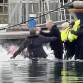 Still from footage depicts James Corden falling into water whilst filming in Eastbourne's Sovereign Harbour. // James Corden falls into the harbour filming for new Apple TV comedy series 'The Choir' with Ruth Jones.