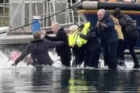 Still from footage depicts James Corden falling into water whilst filming in Eastbourne's Sovereign Harbour. // James Corden falls into the harbour filming for new Apple TV comedy series 'The Choir' with Ruth Jones.