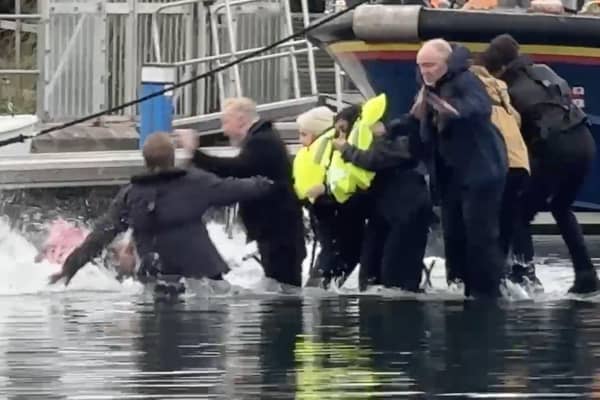 Still from footage depicts James Corden falling into water whilst filming in Eastbourne's Sovereign Harbour. // James Corden falls into the harbour filming for new Apple TV comedy series 'The Choir' with Ruth Jones.