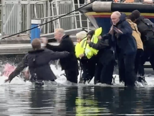 Still from footage depicts James Corden falling into water whilst filming in Eastbourne's Sovereign Harbour. // James Corden falls into the harbour filming for new Apple TV comedy series 'The Choir' with Ruth Jones.