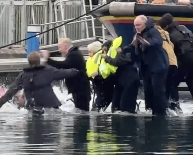 Still from footage depicts James Corden falling into water whilst filming in Eastbourne's Sovereign Harbour. // James Corden falls into the harbour filming for new Apple TV comedy series 'The Choir' with Ruth Jones.