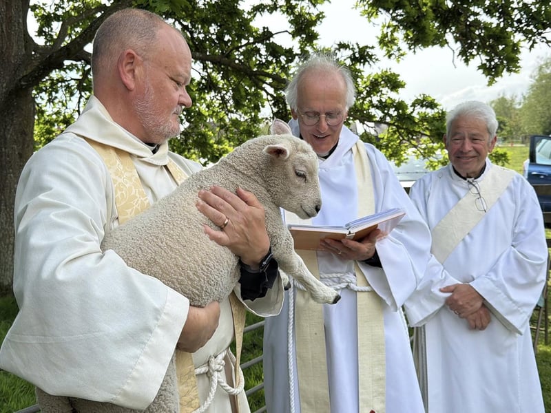 Rev'd Paul White holding the lamb to be blessed
