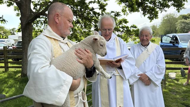 Rev'd Paul White holding the lamb to be blessed
