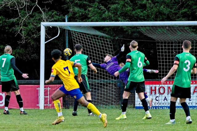 Marcel Powell's shot goes in to help Lancing fight back from 4-1 down to claim a 4-4 draw at Burgess Hill | Picture: Chris Neal