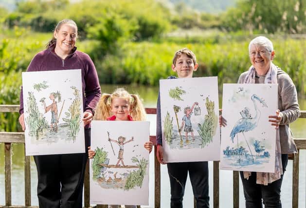 Thomas family at Arundel Wetland Centre for the Drawn to Water trail launch, hold illustrations by Sir Quentin Blake.