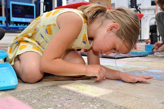 Adding detail to the Chalk Experience pavement artwork