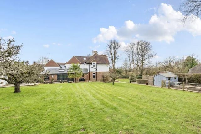 The rear garden provides a sizeable area of lawn, with mature apple trees, summerhouse with heating and power, two sheds and an enclosed vegetable garden with a greenhouse.