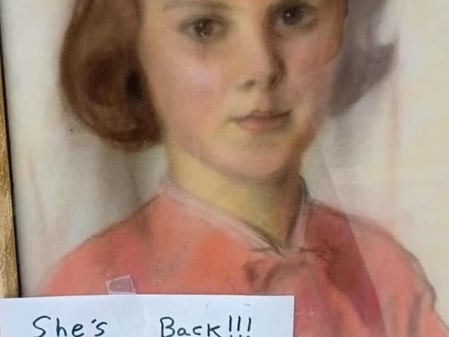 The painting in the window of the charity shop.