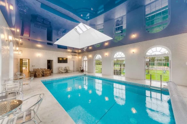 This six bed detached house is on the market with Strutt & Parker for £9,000,000. This new build was completed in 2013 also has six baths, six receptions. Outside there are tennis courts, summer house, gardener’s store, two triple garages and a swimming pool.