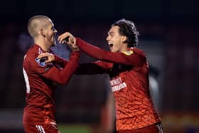 Harry Forster celebrates his winning goal with Crawley Town skipper-for-the-night Ronan Darcy. Picture: Eva Gilbert