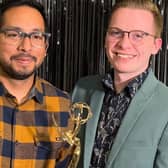 Jordan Hogan (right) receives his Emmy award
