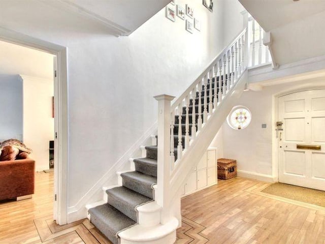 The inviting entrance hall has a charming porthole window
