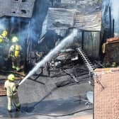 Firefighters tackle a blaze that destroyed two sheds, on Beaconsfield Road