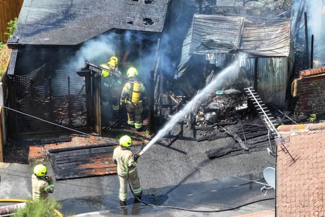 Firefighters tackle a blaze that destroyed two sheds, on Beaconsfield Road