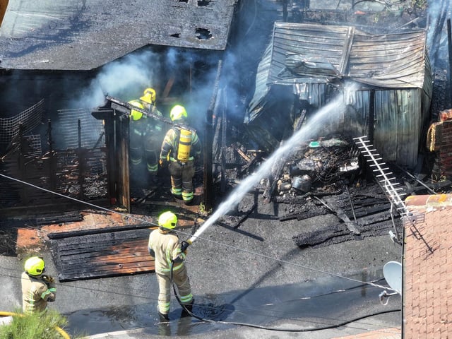 Firefighters tackle a blaze that destroyed two sheds, on Beaconsfield Road