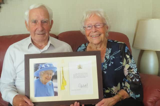 Allan and Patricia Ware with their card from the Queen.