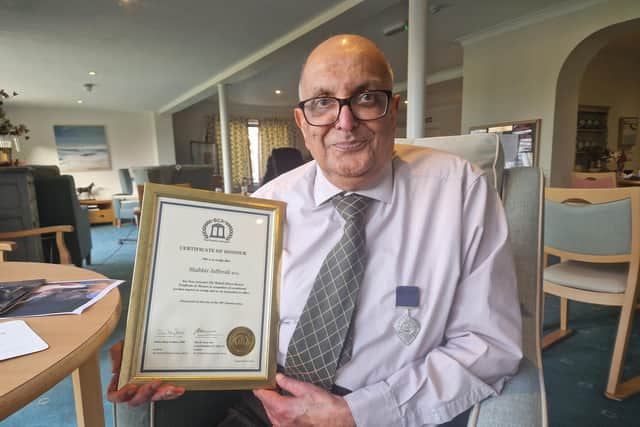 Shabbir Jafferali with his British Citizen Award medal and certificate. Picture: Elaine Hammond / SussexWorld