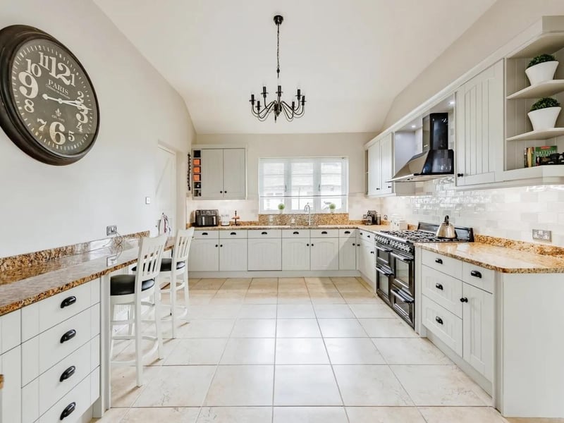 There is a modern fitted kitchen withspace for a large breakfast table