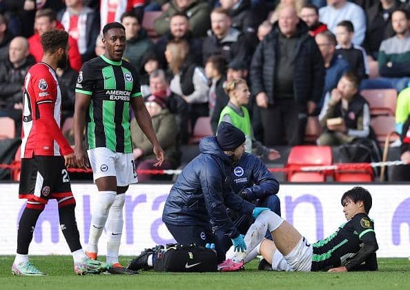 Kaoru Mitoma of Brighton & Hove Albion receives medical treatment at Sheffield United