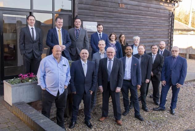 NEW OFFICES: managing director Gareth Pryce, second from left in back row, with his team at the new Three Sixty Design Solutions office at Hills Barn in Chichester. 