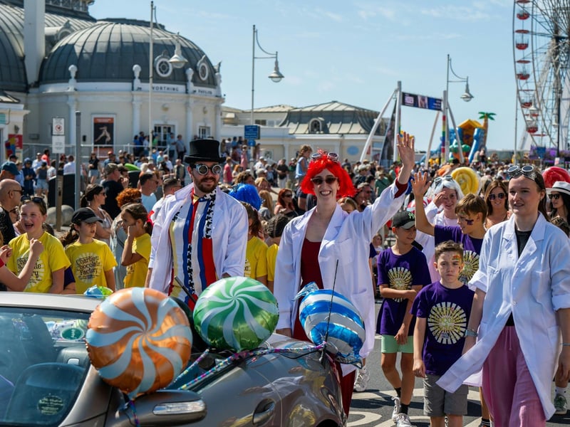 WMTC's Charlie cast members and director Robert Tremayne (in top hat) at the Worthing Carnival on Sunday