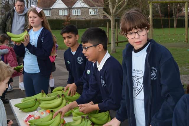 St Richard's students handing out bananas for families and households to enjoy.