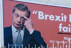 An anti-Brexit billboard with Nigel Farage's face on it has appeared on the side of a building in Eastbourne.