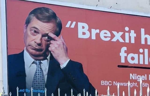 An anti-Brexit billboard with Nigel Farage's face on it has appeared on the side of a building in Eastbourne.