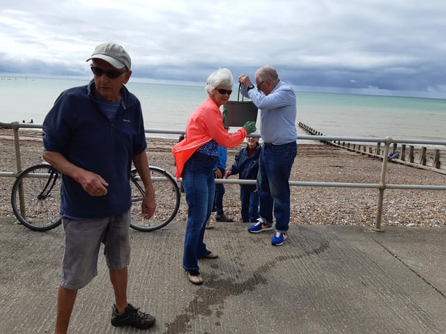 A bucket chain of volunteers from Ferring History Group and Ferring Conservation Group, including Worthing West MP Sir Peter Bottomley, form a bucket chain to bail out nine inches of water from the Ferring pillbox