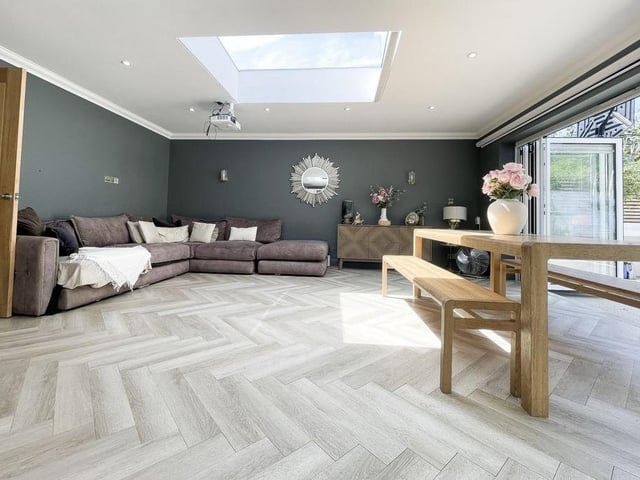 The open-plan living and dining space has bi-folding doors to the garden