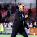 Crawley Town boss doing his trademark celebration with fans after a win. Picture: Eva Gilbert