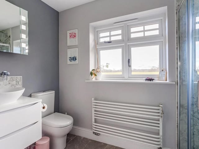 The principal suite has an ensuite shower room and the first floor also offers a bathroom, a separate shower room and a WC
