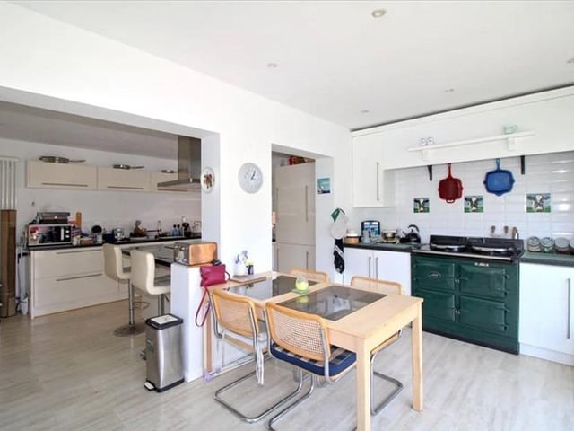 The kitchen features an aga cooker, electric oven and island.