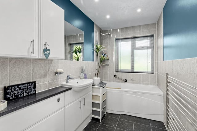 The en Suite is fitted with a white suite, which has a panelled bath with a shower over