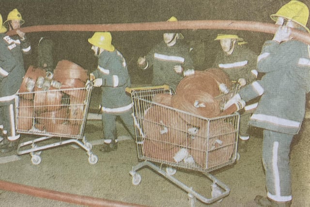 Firefighters used trollies to transport their hose reels to the fire.