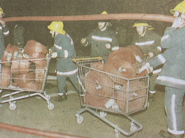 Firefighters used trollies to transport their hose reels to the fire.