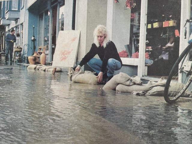 Diana Russell tries to keep water away from her shop in The Hornet.