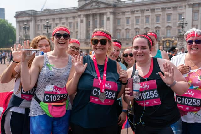 Bryony Gordon and her team in front of Buckingham Palace at the finish line of theThe Vitality Westminster Mile | Photo: Bob Martin for The Vitality Westminster Mile