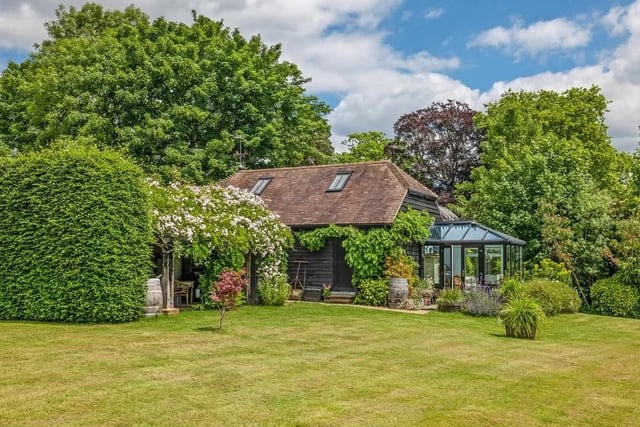 The property has a garden room with a double glazed roof and windows with views over the garden, lake, and countryside